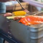 Corn roasts on backyard grills at sunset