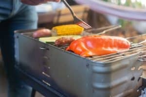 Corn roasts on backyard grills at sunset