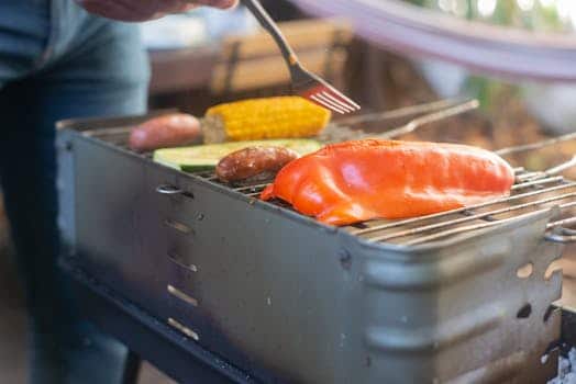Corn roasts on backyard grills at sunset